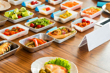 Airplane food presentation with variety of in flight meals