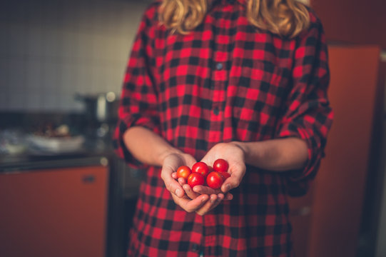 Young woman with tomatoes