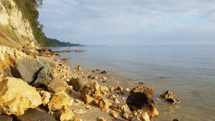 Fototapeta na wymiar beach boulders sand shore calm water