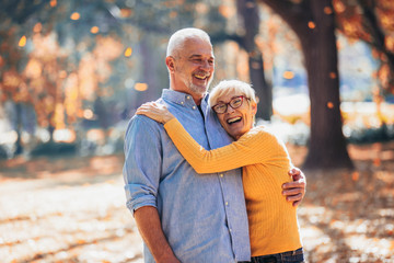 Active seniors on a walk in autumn forest