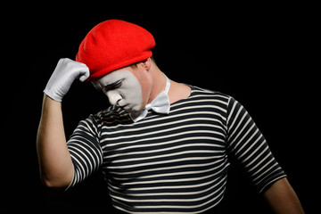 Thoughtful mime, isolated on black