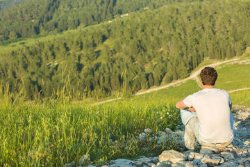 Man resting after hiking with beautiful view.