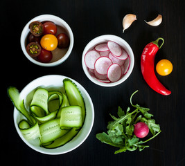 Bowls with ingredients for salad.