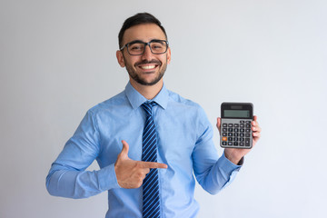 Cheerful banker advertising loan program. Content young man in glasses and tie pointing at...