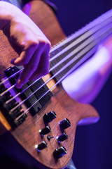A base guitar player playing an electric base
