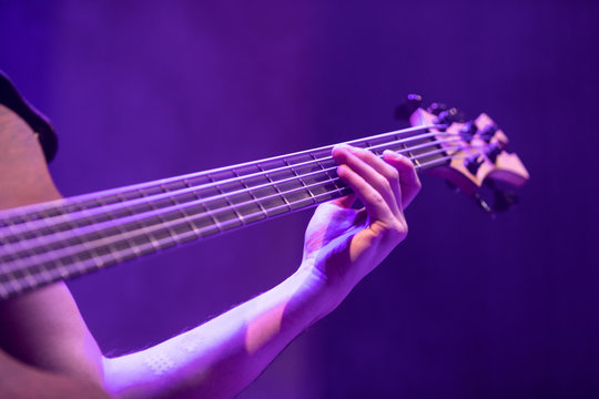 A base guitar player playing an electric base