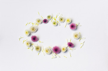 Paper frame with flower on white texture background. Flat lay. Greeting card.