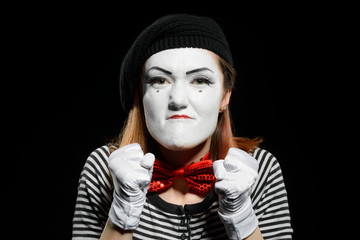 Angry female mime on black