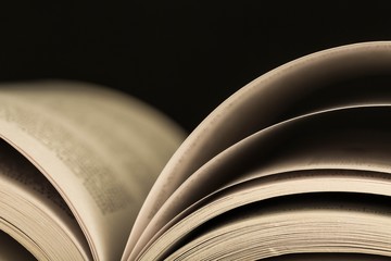 Open Book on the Black Background - Close Up