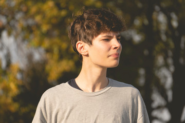 young teenage boy portrait on the autumn field during sunset f