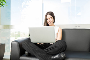 Naklejka premium Businesswoman Doing Survey Of Company On Laptop