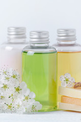 Fototapeta na wymiar natural cosmetic bottles and soap bar with fresh flowers