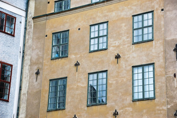 Fototapeta na wymiar Beautiful, wooden windows on the facade of the old house.
