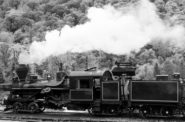 Filling coal into the box of a stam locomotive in black and white-1
