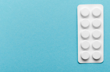 Blister of pills on blue background