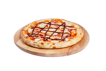 Pizza barbecue with ham, bacon and cheese lies on a round wooden board isolated on a white background.