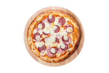Meat pizza with ham, sausage and cheese lies on a round wooden board isolated on a white background.