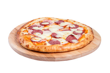 Meat pizza with ham, sausage and cheese lies on a round wooden board isolated on a white background.