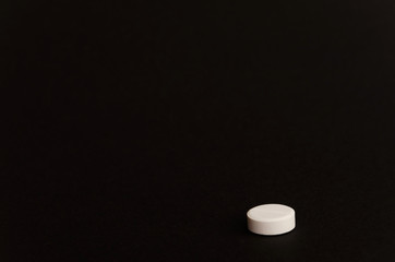 A pill on black background