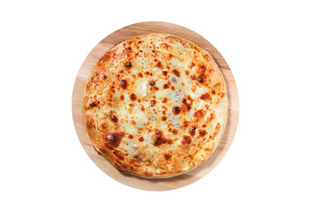 Closed pizza with filling inside lies on a round wooden board isolated on a white background.