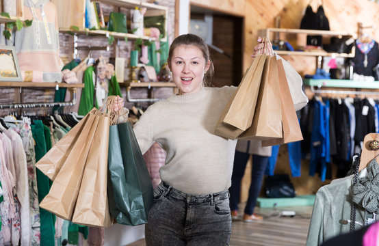Young woman is standing satisfied after shopping