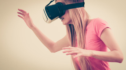 Girl wearing virtual reality goggles.