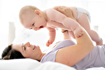 Mother lay on bed with his baby