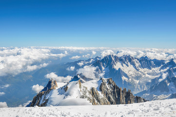 view of the peak of Aiguille du Midi from the summit of Mont Blanc on a sunny day