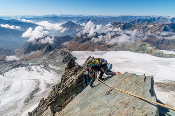 Rock climber on Studlgrat ridge on Grossglockner, highest mountain in Austria