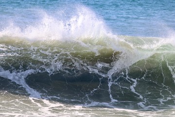 large empty wave crashing in the ocean 