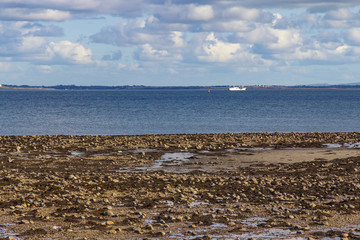 Fototapeta na wymiar Ship in Silverstrand beach with ocean and rocks