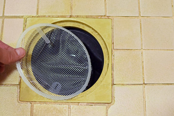Installing hair catcher filter net to shower drain.