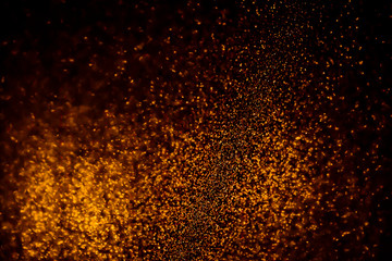 Fototapeta na wymiar Abstract bokeh glitter background. Defocused background. Blurred bright light on black