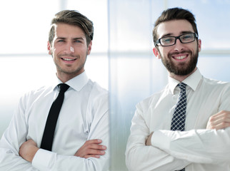 smiling business colleagues standing in a bright office