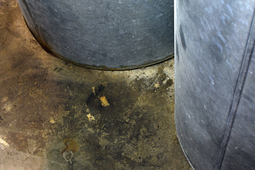 Oil leakage: Heating oil tank has leaked and absorbed to boiler room concrete floor. Copy space.