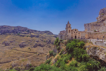 Fototapeta na wymiar Church in the sassi of Matera, Italy and the valley and creek of the Murgia National Park