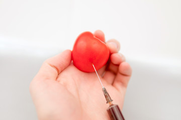tomato in hand with a syringe 