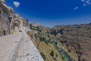 Fototapeta na wymiar The sassi of Matera, Italy and the valley and creek of the Murgia National Park