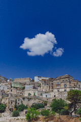 Fototapeta na wymiar Sassi of Matera, Italy under blue sky and white cloud