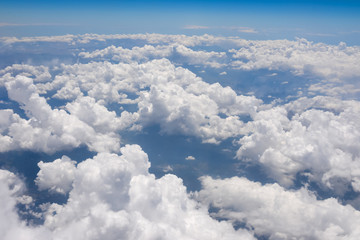 view of the clouds below from the plane