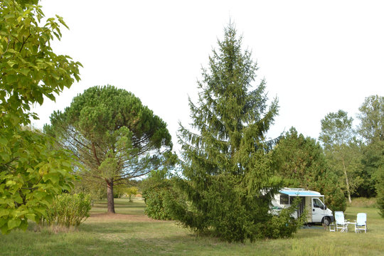 camper met open luifel en campingstoelen op natuurcamping 