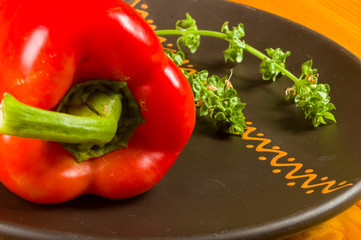 a freshest red paprika, bell pepper in ceramic plate