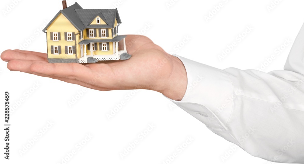 Poster Men's Hand Holding a Model of a House - Isolated