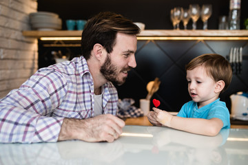 Fototapeta premium Father enjoying in conversation and play with his cute little son.
