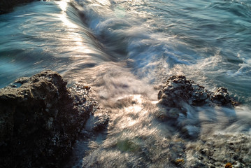 Tidal movement creating a waterfall like motion on the coast.