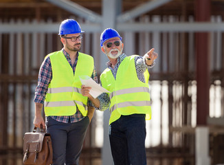 Engineers talking at building site