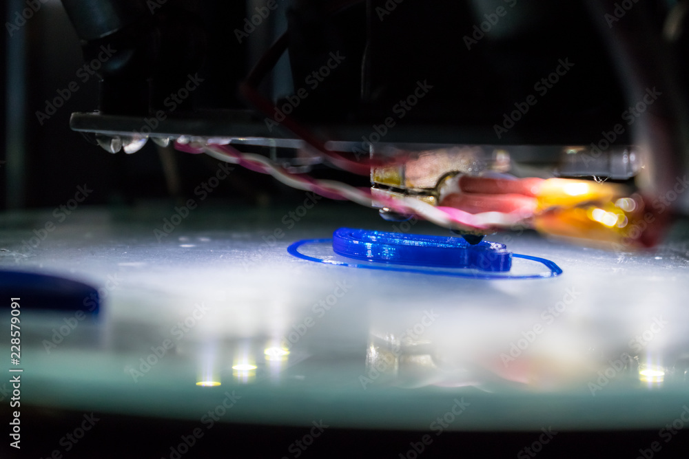 Poster 3d printing process close up. automatic three dimensional 3d printer mechanism prints polymer blue p