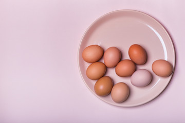 Fototapeta premium Brown chicken eggs on a plate on a table