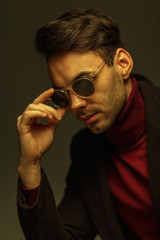 Portrait of a stylish man in sunglasses. Creative color
