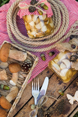 Raw white mushrooms, pine cones and decorations